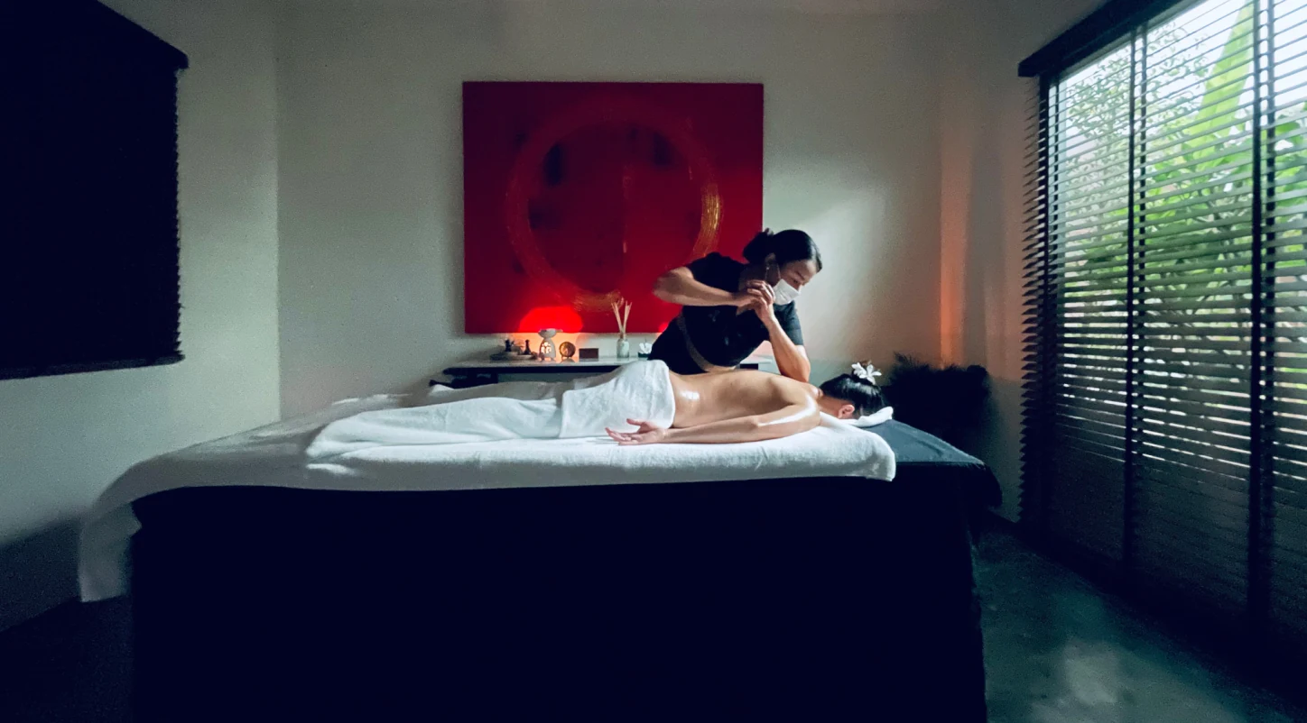 Loft Thai massage room from the spa's photographic archive with a therapist providing professional bodywork