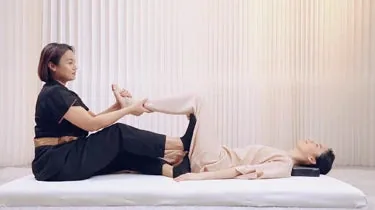 Thai-inspired supported leg stretch demonstrated by OSIM